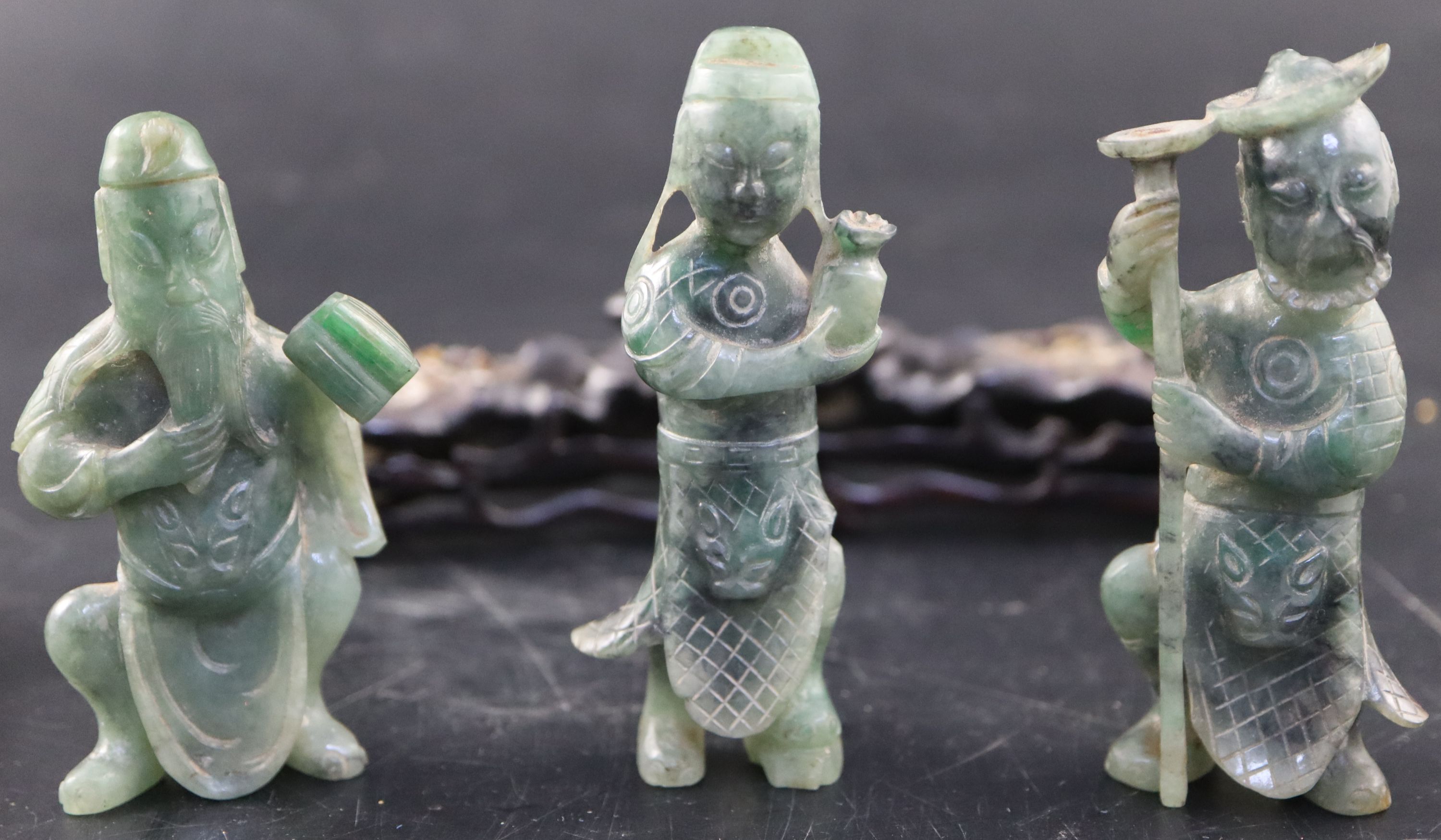 A set of three Chinese carved hardstone figures of immortals, stand; shi shi, malachite fragments etc.